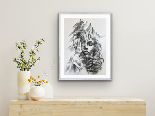Resilient Love art print in a white frame displayed above a wooden counter with modern décor accents.