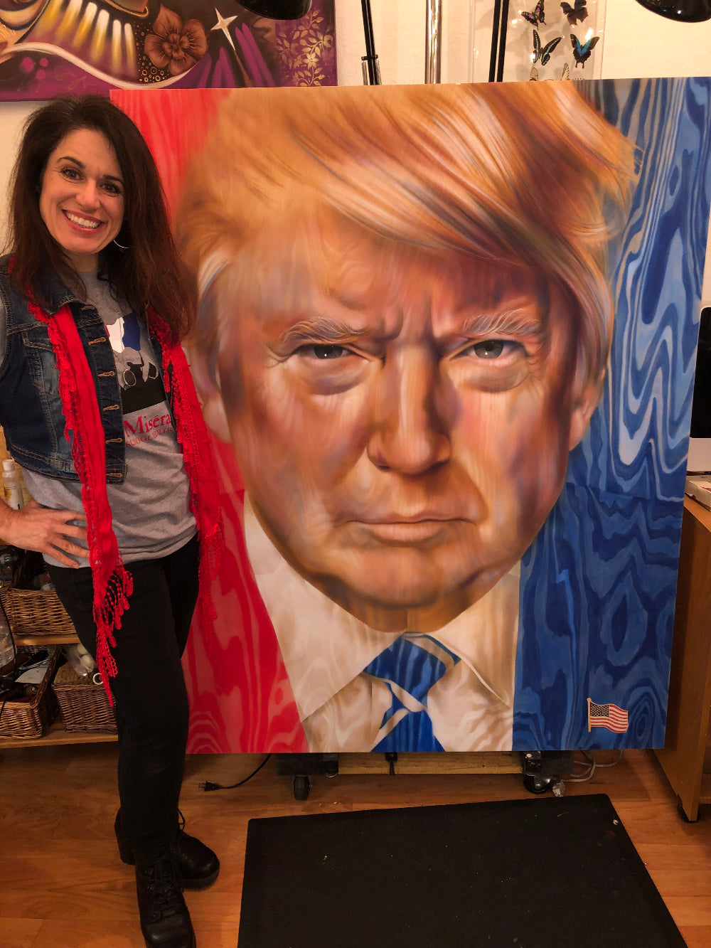 ShenShen with her painting of Donald trump