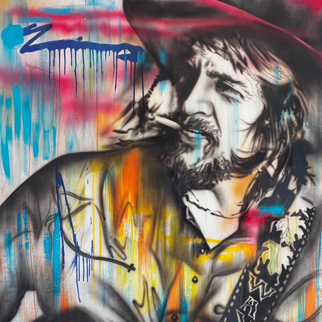 An original mixed media painting featuring a portrait of Waylon Jennings with bold, expressive splashes of color in a vibrant, dynamic style.
