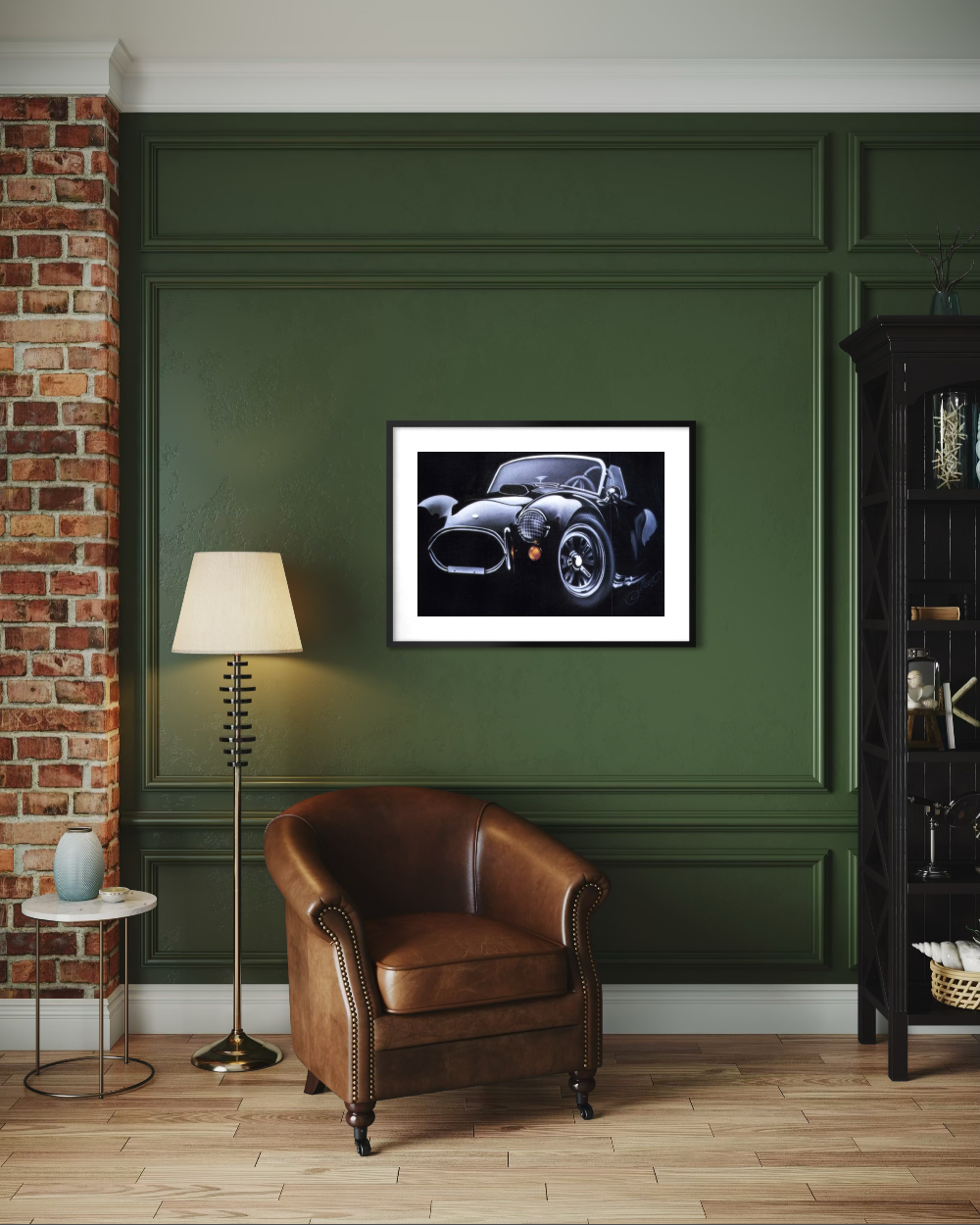 Living room with a brown leather armchair, floor lamp, and framed picture of a car on a green wall. ac cobra limited edition paper fine art print reproduction by shenshen.