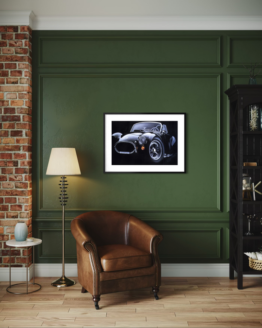 Living room with a brown leather armchair, floor lamp, and framed picture of a car on a green wall. ac cobra limited edition paper fine art print reproduction by shenshen.