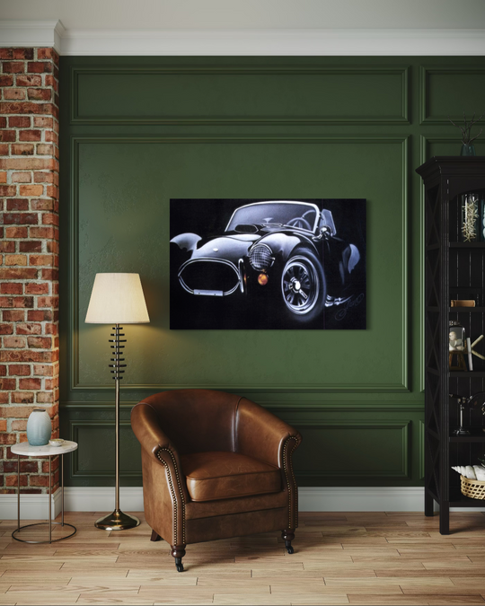 Room interior with a leather armchair, lamp, and framed picture of a car on a green wall. ac cobra limited edition canvas giclee fine art print reproduction by shenshen.