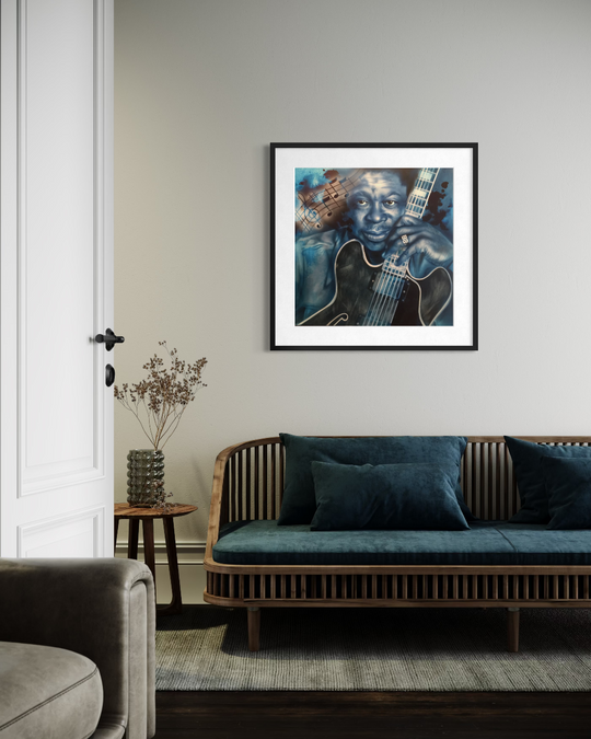 Living room with a framed portrait of a musician holding a guitar on the wall above a wooden sofa. BB King Blues fine art reproduction limited edition paper print by shenshen.