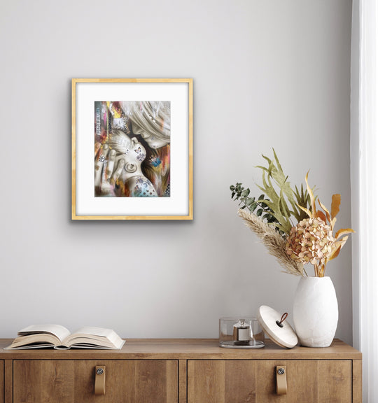 Beautiful life art print displayed above a boho wooden cabinet.