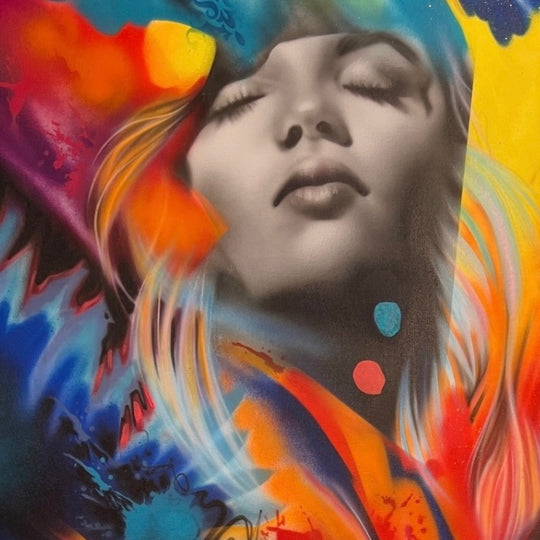 An abstract painting featuring a stylized female face surrounded by vibrant, bold colors with dynamic brushstrokes.