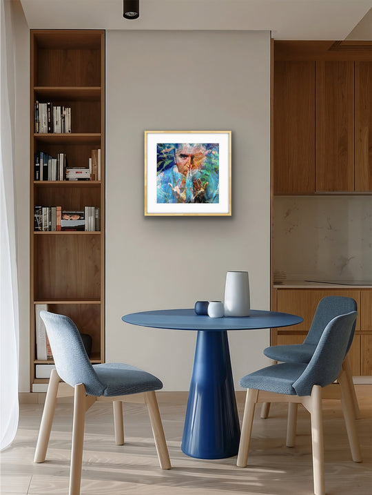 Modern dining area with a blue table and chairs, bookshelf, and framed artwork on the wall.