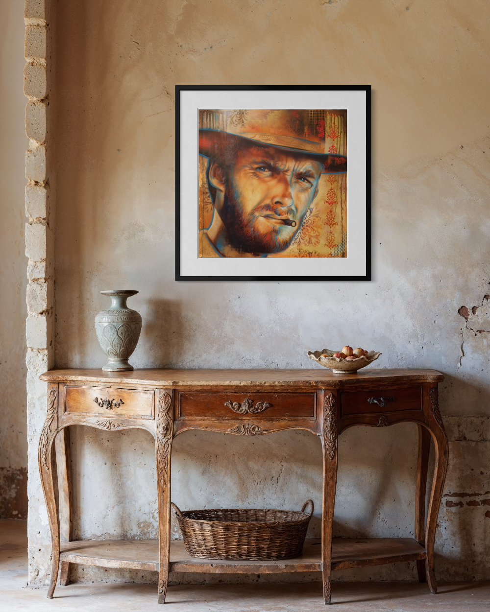 Framed portrait of a man with a hat on a wall above a wooden console table. Clint Eastwood Paper Reproduction — Limited Edition Fine Art Print by ShenShen.
