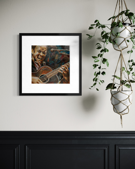 Framed artwork of a musician playing guitar on a wall with a plant in the corner. Dave Matthews limited edition reproduction fine art print by ShenShen.