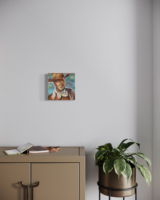 Small painting of a cowboy on a wall above a desk with a plant next to it. John Wayne fine art reproduction limited edition Canvas giclee by shenshen.