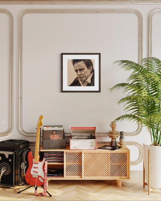 Living room with a wooden cabinet, guitar, records, and framed picture on a wall. johnny cash portrait fine art print limited edtion by shenshen