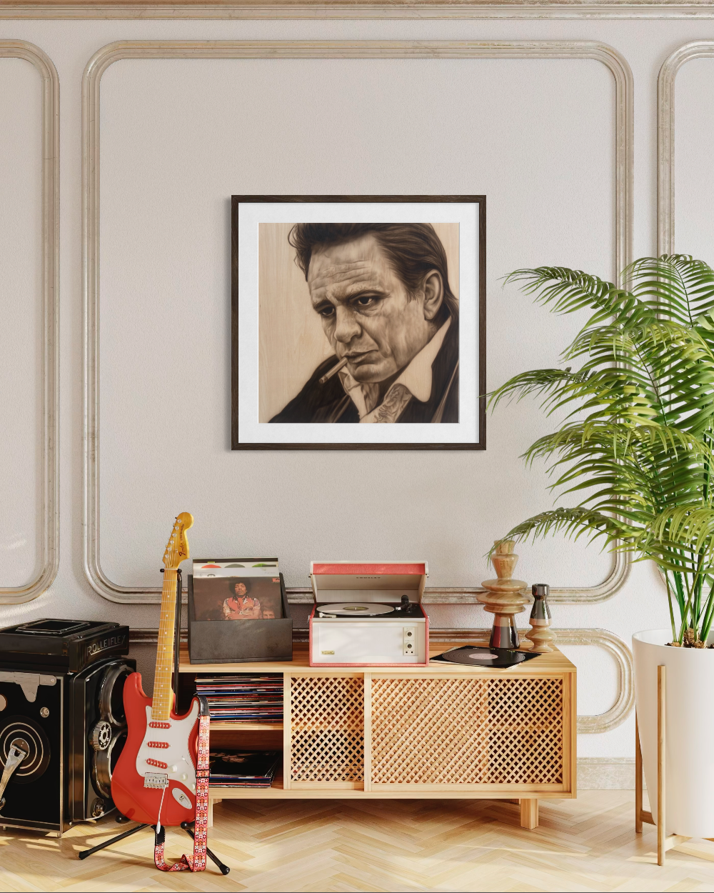 Framed portrait above a wooden cabinet with records and a guitar, in a room with decorative wall molding and a plant. Johnny Cash by Shenshen