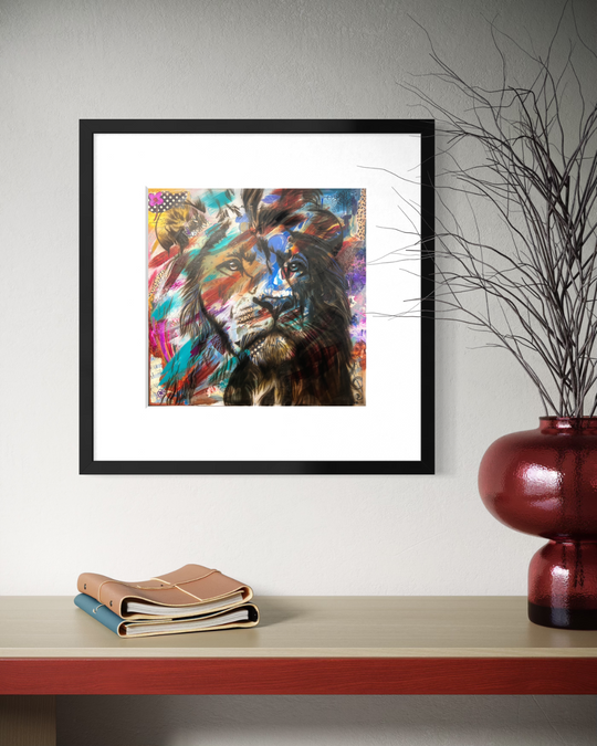 Framed colorful lion artwork on a wall above a shelf with books and a vase. Fine art print limited edition reproduction by ShenShen.
