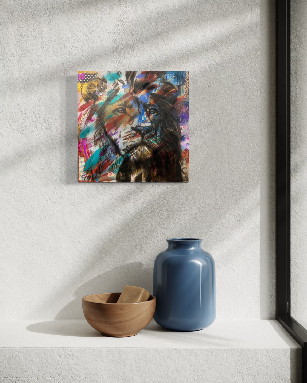Colorful abstract lion painting on a white wall with a blue vase and wooden bowl below. Fine art print limited edition reproduction by ShenShen.