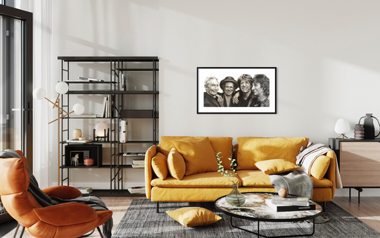 Modern living room with a yellow sofa, orange armchair, and decorative wall art.Rolling Stones by ShenShen limited reproduction paper fine art print.