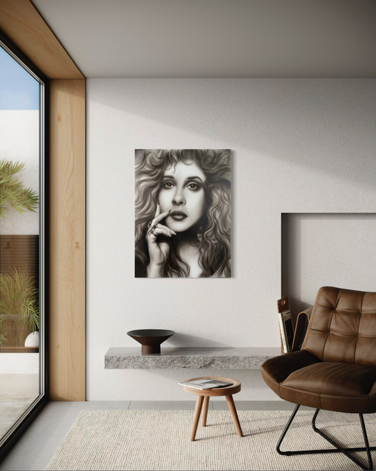 Modern living room with a portrait of a woman on the wall, a brown leather chair, and a small wooden table. Stevie Nicks by ShenShen limited edition reproduction canvas giclee fine art print.